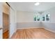 Charming bedroom featuring hardwood floors, large windows, and a closet at 8813 Baseline Rd, Lafayette, CO 80026