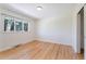 Clean, bright bedroom with hardwood floors, fresh white paint, and a large window offering outdoor views and lots of light at 8813 Baseline Rd, Lafayette, CO 80026