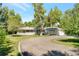 Charming ranch-style home with lush landscaping and a circular driveway at 8813 Baseline Rd, Lafayette, CO 80026