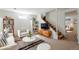 Staged basement living area with stylish furniture, shelving and carpeted stairs at 8813 Baseline Rd, Lafayette, CO 80026