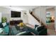 Staged basement living area with modern furniture and stairs leading to another floor at 8813 Baseline Rd, Lafayette, CO 80026