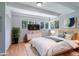 Comfortable main bedroom with hardwood floors, panelled walls, lots of light, and a cozy bed with soft linens at 8813 Baseline Rd, Lafayette, CO 80026