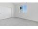 Bright bedroom features neutral paint, window, and sliding closet door at 804 Summer Hawk Dr # 7301, Longmont, CO 80504