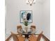 Dining area with glass table, four chairs, modern art and a patterned rug at 804 Summer Hawk Dr # 7301, Longmont, CO 80504