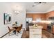 Bright kitchen features stainless appliances, granite countertops, dining table, and wooden floors at 804 Summer Hawk Dr # 7301, Longmont, CO 80504