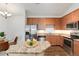 Kitchen features a stainless steel refrigerator and microwave, plenty of cabinets and counter space at 804 Summer Hawk Dr # 7301, Longmont, CO 80504