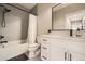 Modern bathroom featuring gray hexagonal tile, white vanity, and a sleek black shower fixture at 8623 S Wadsworth Ct, Littleton, CO 80128