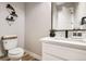 Stylish powder room with modern vanity, marble countertop, and minimalist decor at 8623 S Wadsworth Ct, Littleton, CO 80128