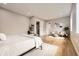 Spacious bedroom with hardwood floors, a seating area, and neutral color palette at 8623 S Wadsworth Ct, Littleton, CO 80128
