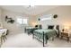 Comfortable bedroom with two beds, carpet, large windows, and simple decor at 8623 S Wadsworth Ct, Littleton, CO 80128