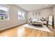 Bright bedroom featuring hardwood floors, neutral decor, and abundant natural light at 8623 S Wadsworth Ct, Littleton, CO 80128