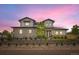 Stunning two-story home highlighted by a vibrant, colorful sky at sunset and meticulously crafted landscaping at 8623 S Wadsworth Ct, Littleton, CO 80128