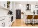 Well-designed kitchen features white cabinets, stainless appliances, and a center island at 8623 S Wadsworth Ct, Littleton, CO 80128