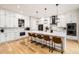 Bright kitchen with large island, white cabinets, modern appliances, and pendant lighting at 8623 S Wadsworth Ct, Littleton, CO 80128