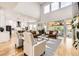 Open-concept living room with high ceilings, a modern kitchen, and a seamless flow to the outdoor space at 8623 S Wadsworth Ct, Littleton, CO 80128