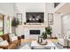 Cozy living room with a stone fireplace, shiplap accents, modern decor, and comfortable seating at 8623 S Wadsworth Ct, Littleton, CO 80128