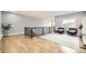 Open loft area with wood floors, modern railing, and comfortable seating at 8623 S Wadsworth Ct, Littleton, CO 80128