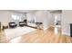 Second-floor living area with wood floors, plush seating, and a bright, airy feel at 8623 S Wadsworth Ct, Littleton, CO 80128