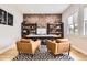 Home office boasts a brick accent wall, built-in shelving, and ample natural light at 8623 S Wadsworth Ct, Littleton, CO 80128