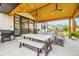 Inviting covered patio with outdoor seating, dining space, and a built-in grill at 8623 S Wadsworth Ct, Littleton, CO 80128