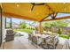 Covered outdoor patio with dining and grilling areas, perfect for entertaining at 8623 S Wadsworth Ct, Littleton, CO 80128