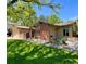 Charming home features a brick exterior, well-maintained lawn, garden and attached garage at 7019 S Windermere St, Littleton, CO 80120
