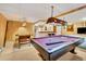 Spacious finished basement featuring a pool table, foosball table, and bar area at 7019 S Windermere St, Littleton, CO 80120