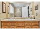 Bathroom vanity featuring double sinks, granite countertops, and wood cabinetry for ample storage space at 7019 S Windermere St, Littleton, CO 80120