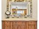 Bathroom vanity featuring a marble countertop, wooden drawers, and decorative mirror at 7019 S Windermere St, Littleton, CO 80120