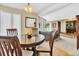 Dining room with wood table and chairs adjacent to the living room with access to a home office at 7019 S Windermere St, Littleton, CO 80120