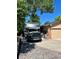 Driveway with RV parking leading to a brick home featuring a two-car garage and mature trees at 7019 S Windermere St, Littleton, CO 80120