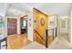 Hallway featuring hardwood floors, a wood accent wall, and staircase leading upstairs at 7019 S Windermere St, Littleton, CO 80120