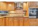 Updated kitchen with custom cabinetry, granite countertops, and modern stainless steel appliances at 7019 S Windermere St, Littleton, CO 80120