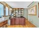 Home office with a built-in bookcase, a wooden desk, and natural light from the windows at 7019 S Windermere St, Littleton, CO 80120