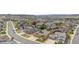 Expansive aerial view capturing a community with diverse architectural styles, lush landscaping, and roadway at 3995 Manorbrier Cir, Castle Rock, CO 80104