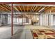 Spacious unfinished basement featuring exposed wood beams and framing, awaiting personalization and renovation at 3995 Manorbrier Cir, Castle Rock, CO 80104