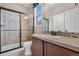 Bathroom featuring a shower with glass door, tiled backsplash, vanity, and neutral color scheme at 3995 Manorbrier Cir, Castle Rock, CO 80104