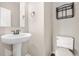 Half bath featuring a modern sink, mirror, and toilet at 3995 Manorbrier Cir, Castle Rock, CO 80104