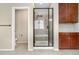 Modern bathroom featuring a glass-enclosed shower with a built-in bench and sleek cabinetry at 3995 Manorbrier Cir, Castle Rock, CO 80104