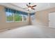 Bright bedroom with neutral walls, plush carpet, ceiling fan and large window at 3995 Manorbrier Cir, Castle Rock, CO 80104