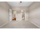 Spacious carpeted bedroom with entry and bathroom doorway views at 3995 Manorbrier Cir, Castle Rock, CO 80104