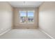 Neutral bedroom with plush carpet and a window framing a neighborhood view at 3995 Manorbrier Cir, Castle Rock, CO 80104