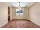 Bright dining room features hardwood floors, natural light and a large window at 3995 Manorbrier Cir, Castle Rock, CO 80104