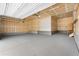 Clean, empty garage with smooth concrete floors, white walls, and an automated door system at 3995 Manorbrier Cir, Castle Rock, CO 80104