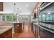 Open-concept kitchen flowing into the living area featuring granite counters and stainless steel appliances at 3995 Manorbrier Cir, Castle Rock, CO 80104
