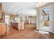 Open-concept kitchen with wood floors, granite countertops, and stainless steel appliances at 3995 Manorbrier Cir, Castle Rock, CO 80104