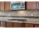 Gourmet kitchen with stainless steel appliances, tile backsplash, and granite countertops at 3995 Manorbrier Cir, Castle Rock, CO 80104