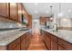 Open kitchen showcases wooden floors, granite countertops, stainless steel appliances, and a center island at 3995 Manorbrier Cir, Castle Rock, CO 80104