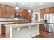 Modern kitchen featuring stainless steel appliances, a center island, and ample cabinet space for storage at 3995 Manorbrier Cir, Castle Rock, CO 80104