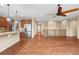 Open living area with stainless steel appliances, granite countertops, and hardwood floors at 3995 Manorbrier Cir, Castle Rock, CO 80104